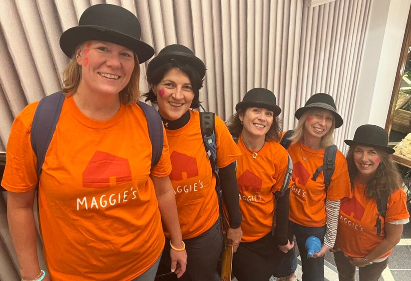 Five women wearing orange Maggie's T-shirts and bowler hats for their fundraising activity