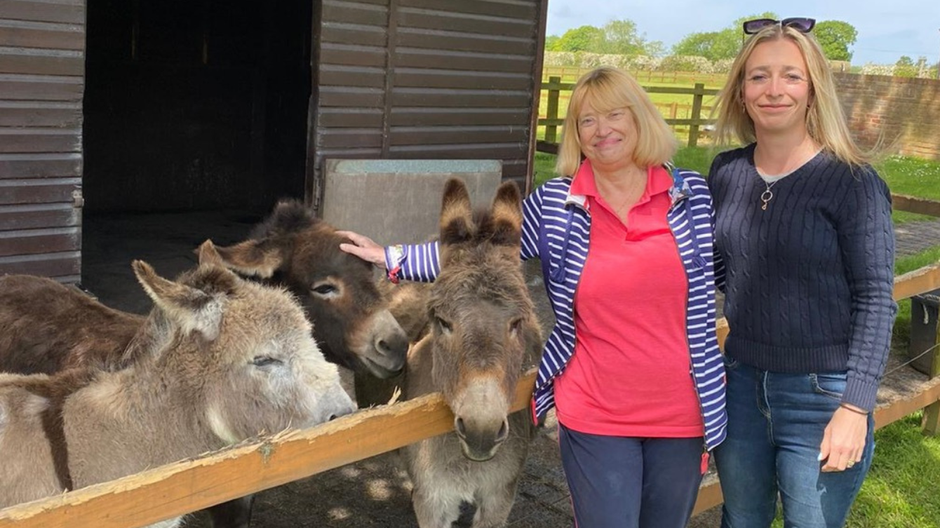 Hannah and her mum at a donkey sanctuary